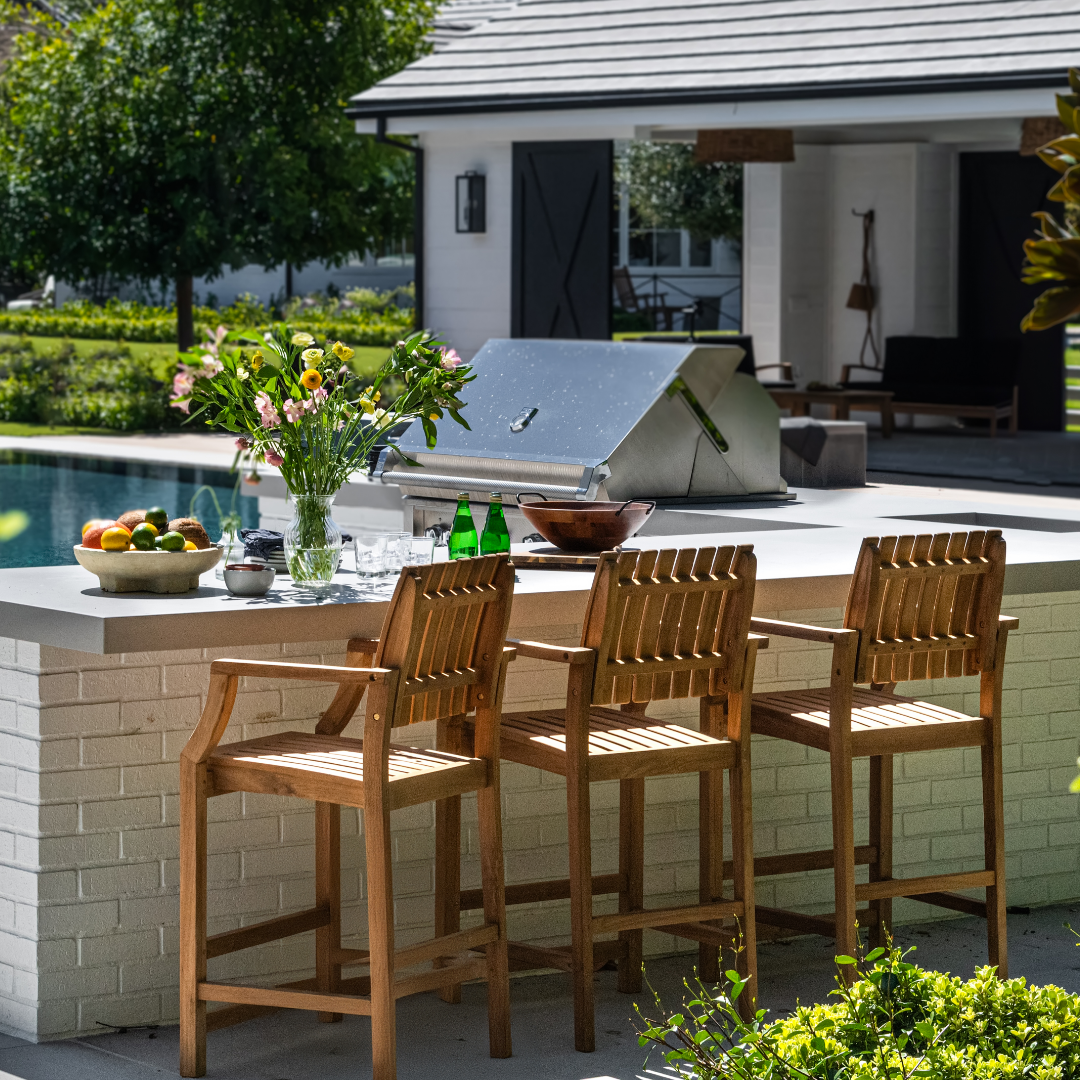 Black metal outdoor bar chairs by wooden table