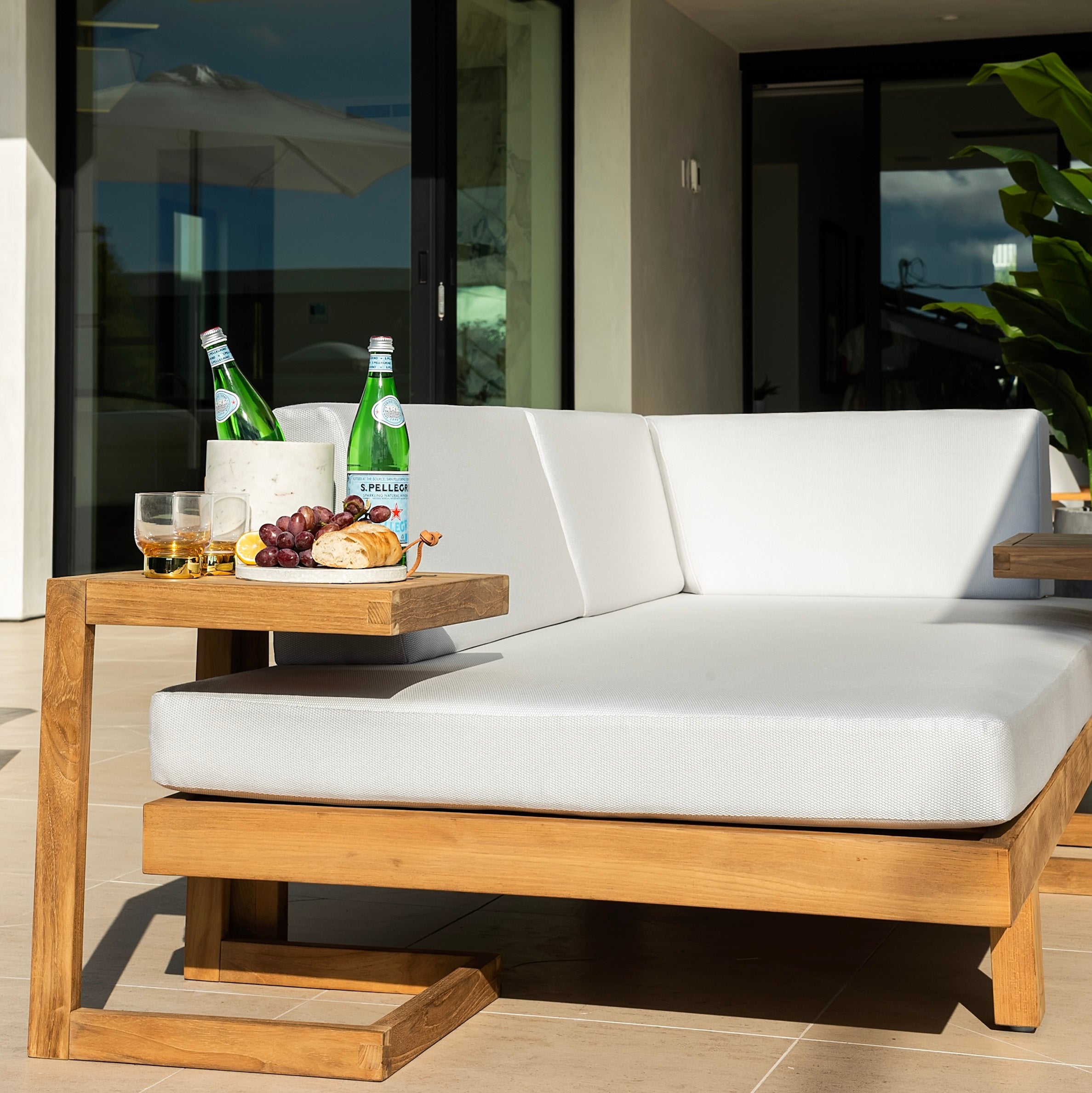 C-shape teak outdoor accent C-table next to lounge