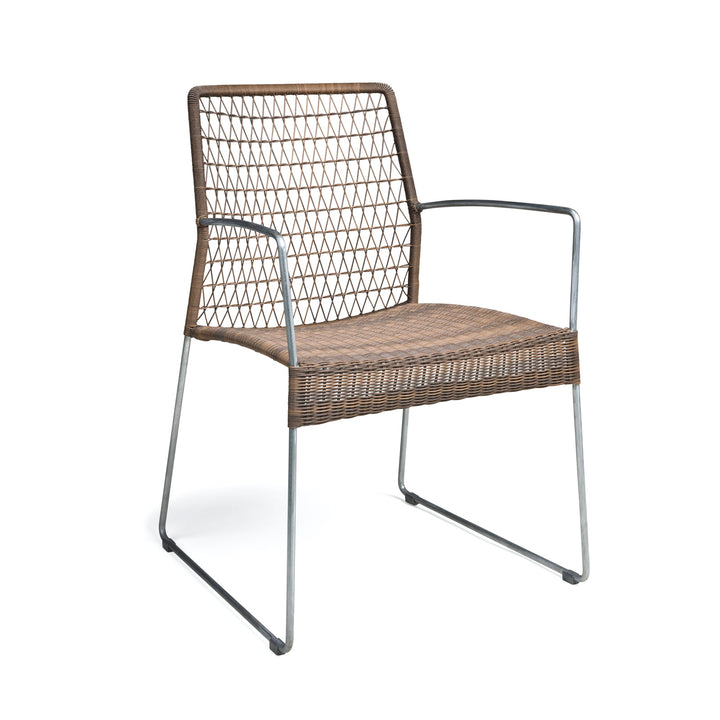 A wicker chair with metal legs and armrests sits empty on a white background, showcasing a woven backrest with a diamond pattern.