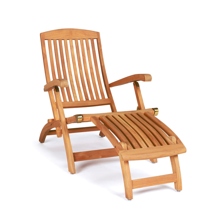 A wooden deck chair with slatted backrest and foldable leg rest sits on a plain white background. The chair features armrests and brass hinges for adjustment.