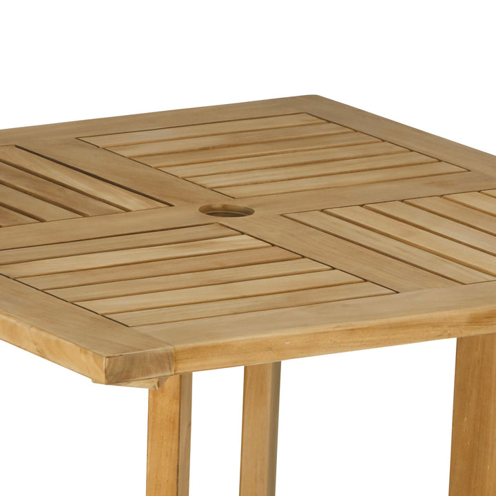 Wooden square table displaying a slatted pattern and central circular hole, supported by vertical legs. Set against a plain white background.