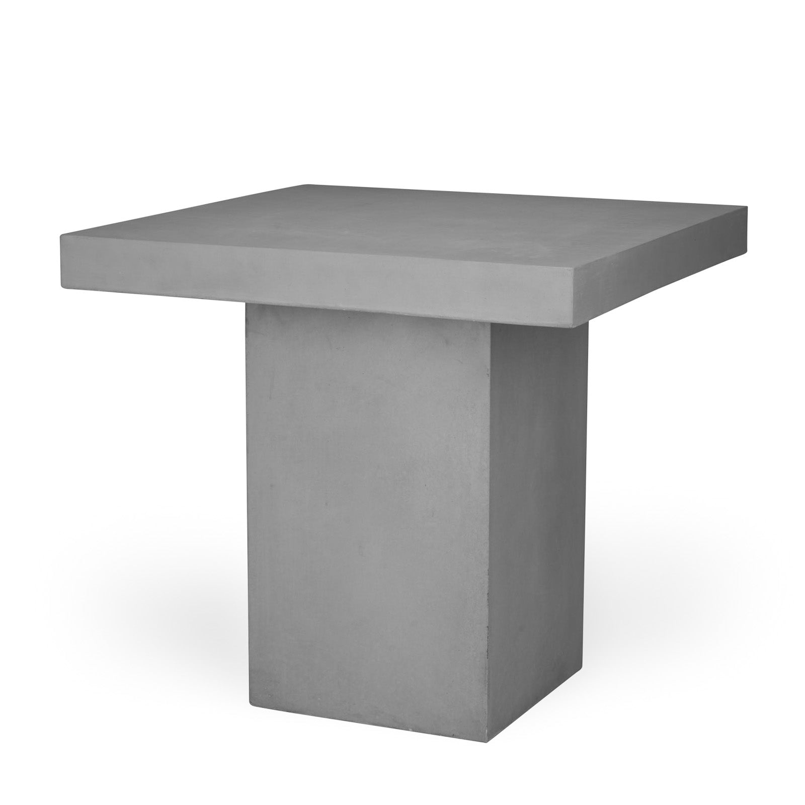 A square, solid, gray concrete table with a flat top and block-like base, standing in a well-lit, featureless space.