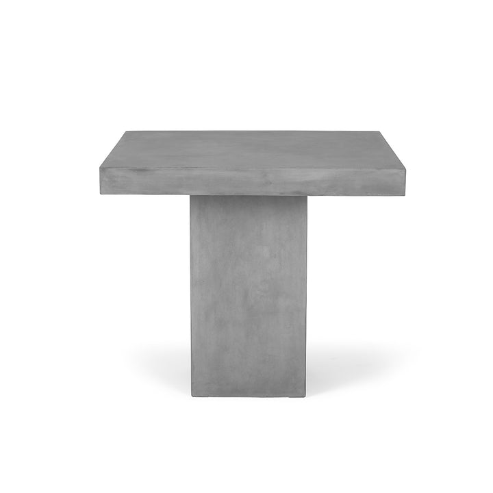 A square gray concrete table stands on a sturdy pedestal base, set against a plain white background.