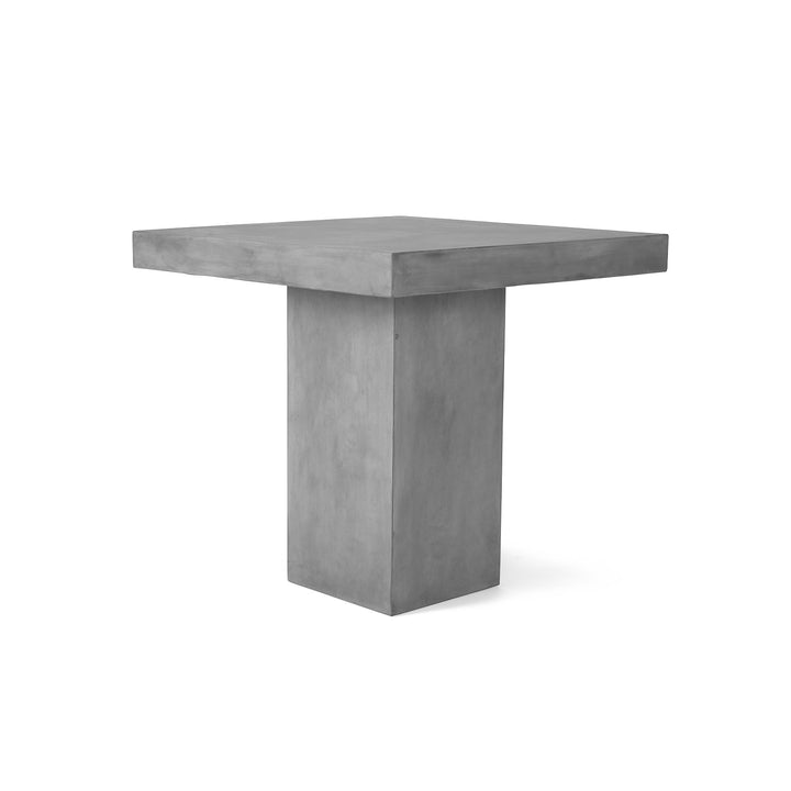 Square concrete table stands on a thick pedestal, isolated against a plain white background.