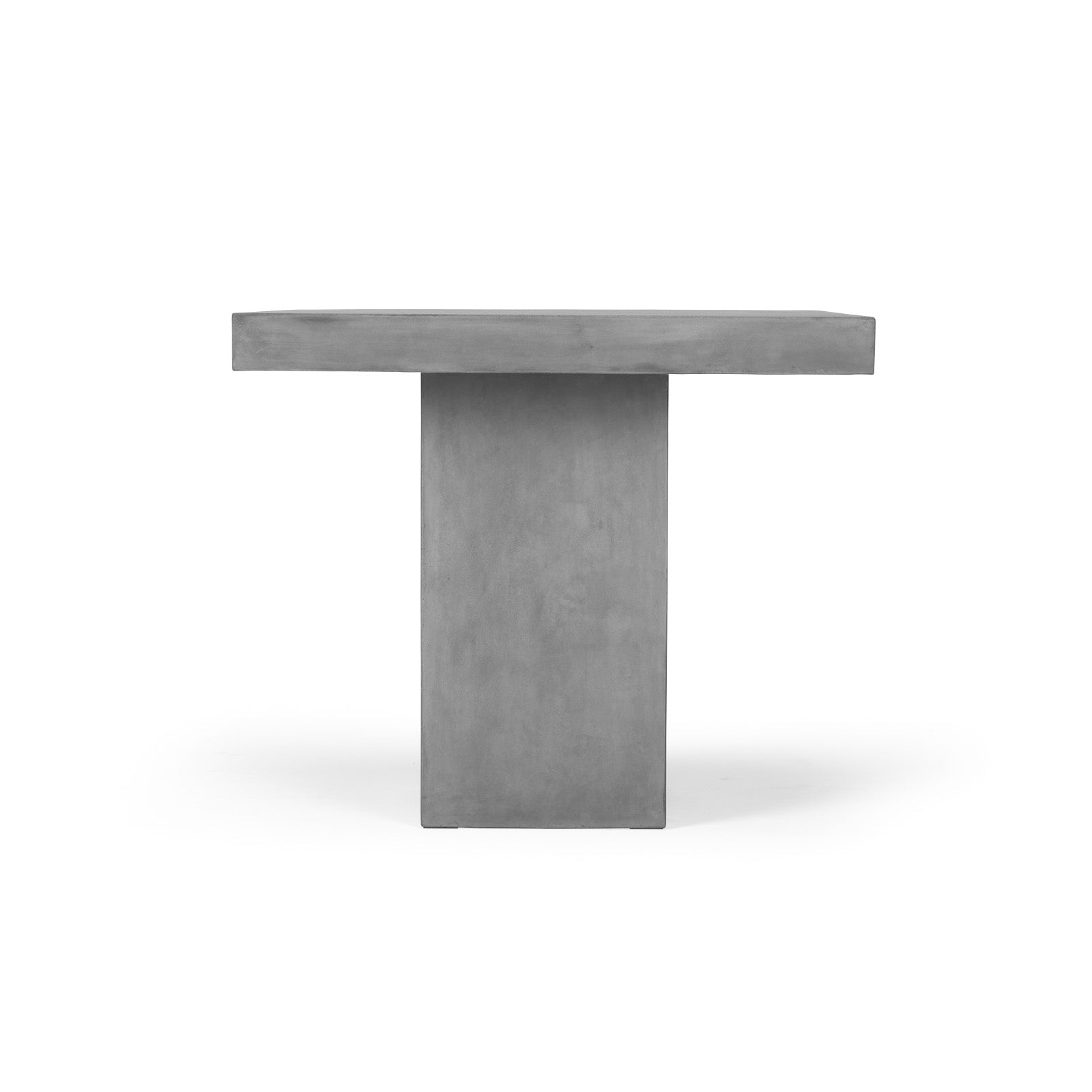 A rectangular concrete pedestal table stands upright, featuring clean lines and a solid rectangular base, set against a plain white background.