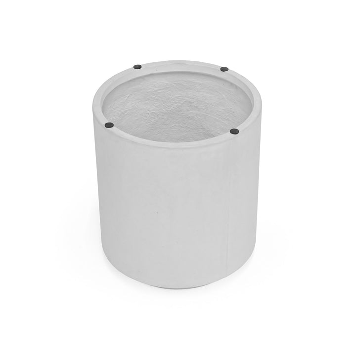 A cylindrical, grey concrete planter with a smooth exterior and four small black dots on the rim, sits against a plain white background.