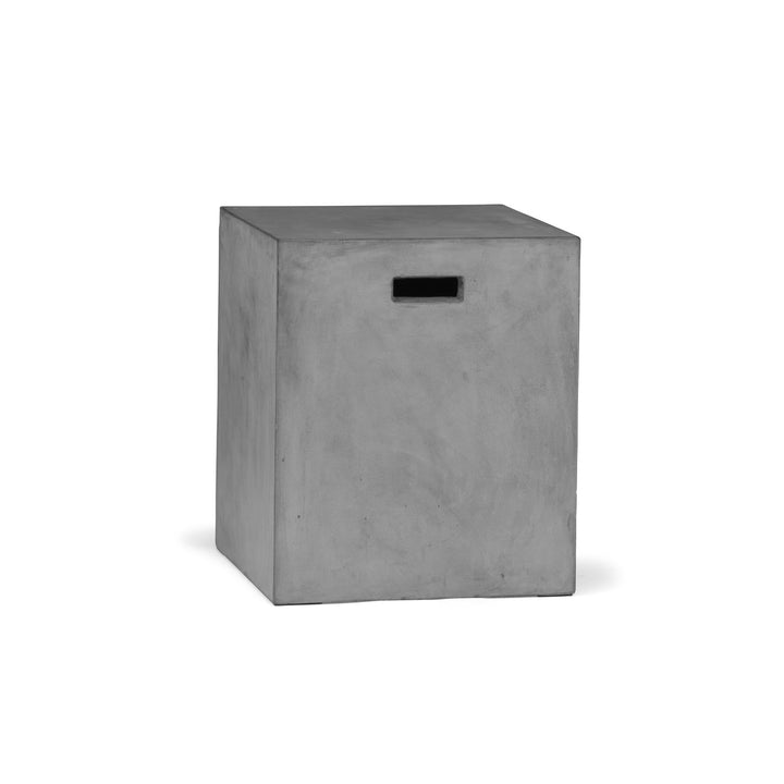 A gray, solid concrete cube with a horizontal slot on the front rests on a plain white background, suggesting minimalist design and utilitarian functionality.