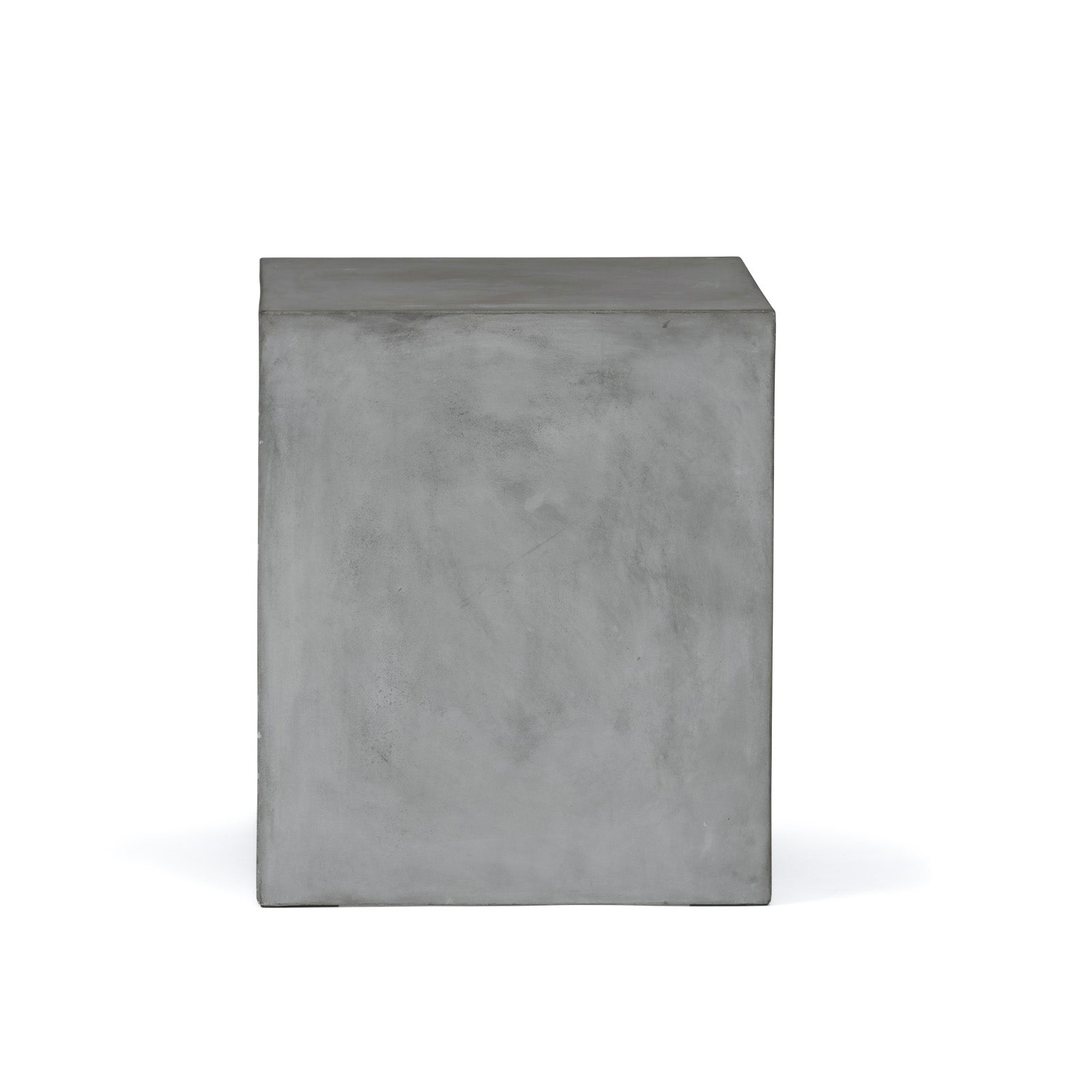 A gray concrete cube stands upright, displaying a smooth surface with light texture variations, set against a plain white background.