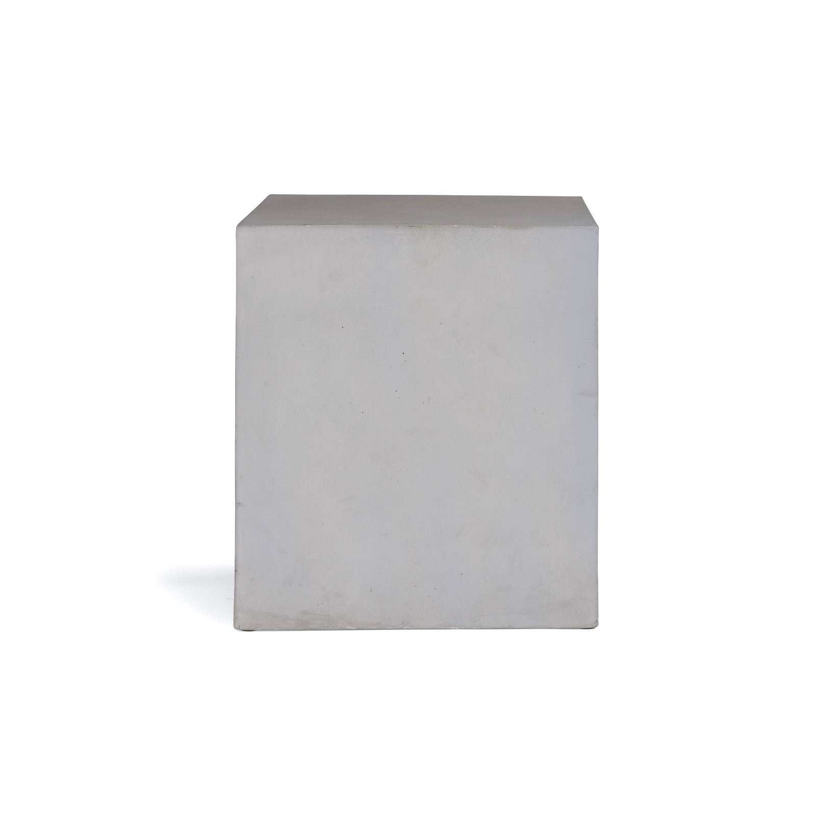 A large, plain white cube stands stationary against a solid white background, casting a faint shadow to its left side.