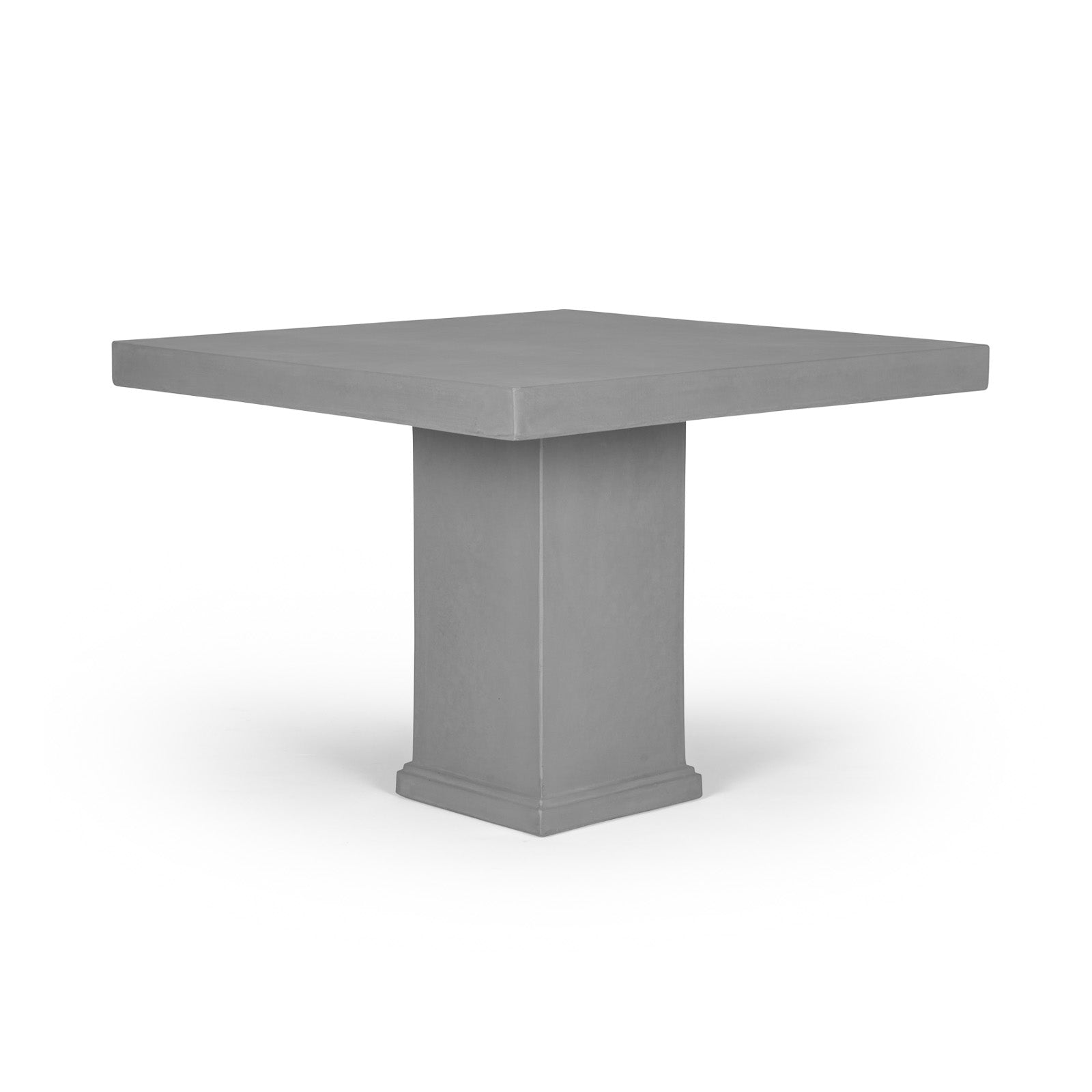 A square, grey table with a thick, central pedestal base is positioned against a plain white background, emphasizing its modern, minimalist design.