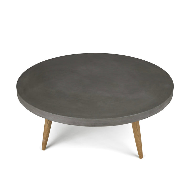 A round, dark gray table with a smooth surface stands on three wooden legs, set against a plain white background.