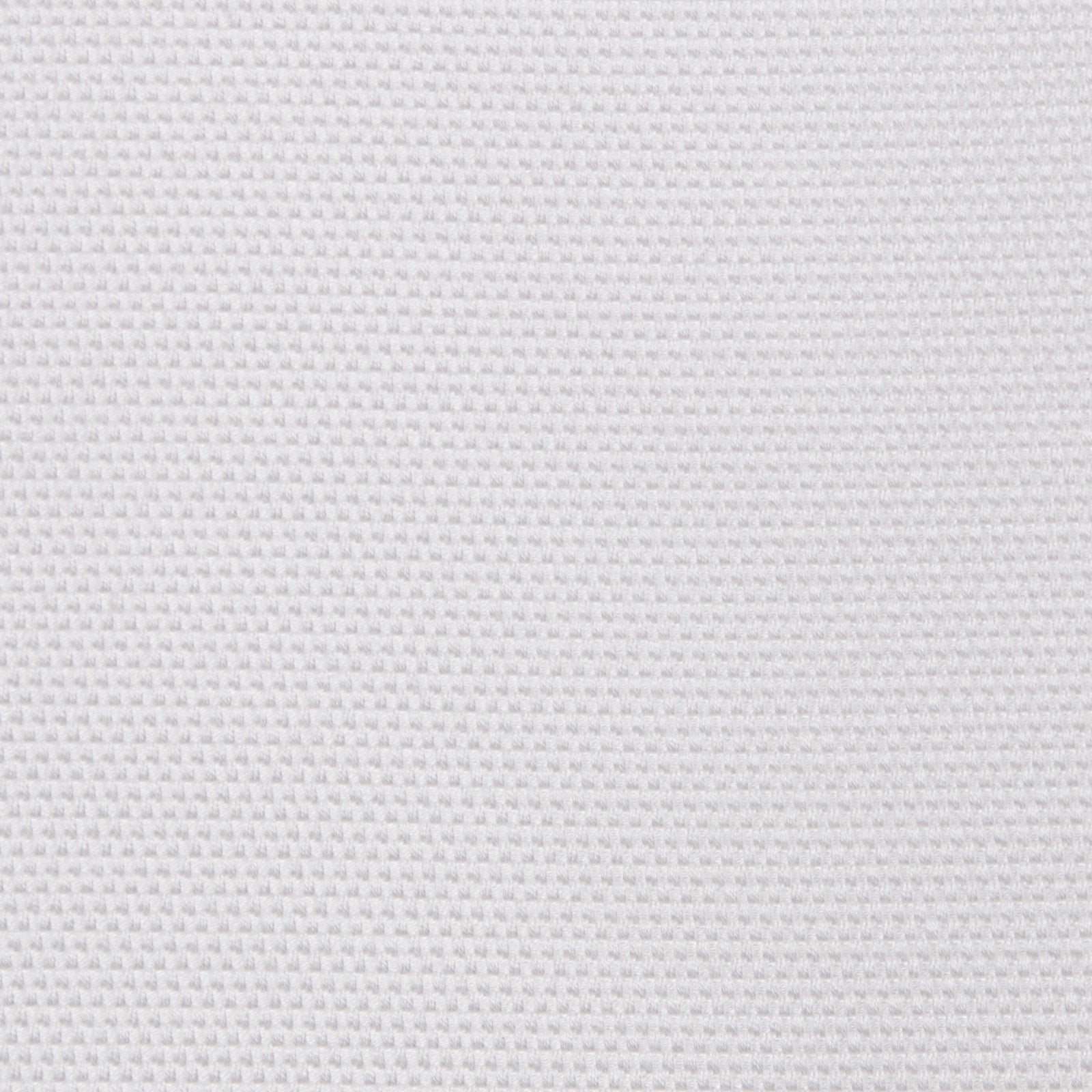 A white surface displays a uniform, textured pattern resembling a grid or waffle, set against a simple and unobtrusive background.