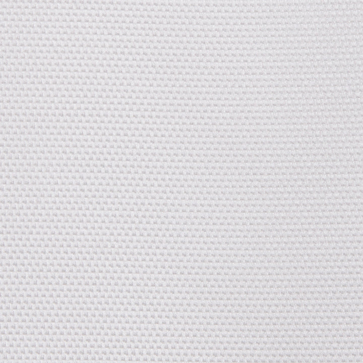 A white surface displays a uniform, textured pattern resembling a grid or waffle, set against a simple and unobtrusive background.