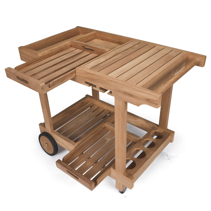 Wooden cart featuring slatted surfaces with two levels; upper level includes a removable tray and lower shelves for storage. Equipped with wheels, it is designed for transporting items.