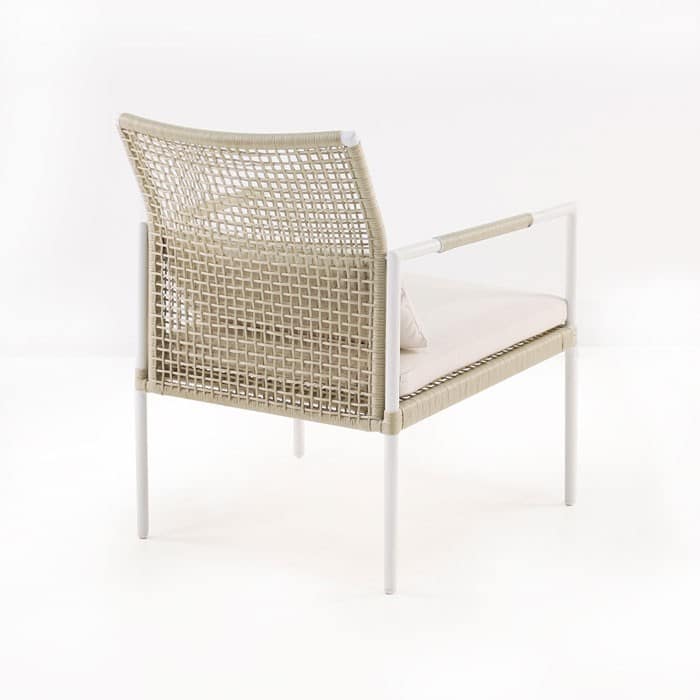 A wicker chair with metal legs and armrests stands independently, featuring a cushioned seat. The setting is a minimalistic, white background.