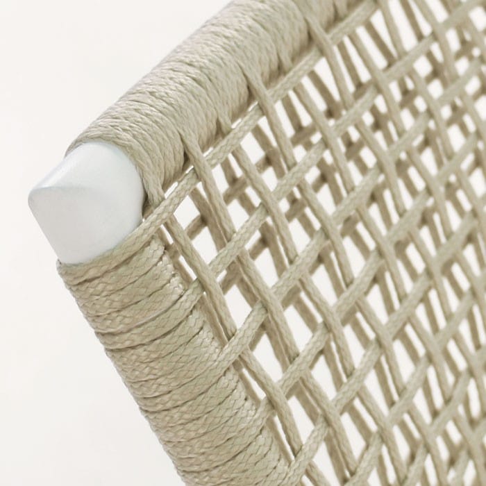 A close-up of a woven beige rope netting wrapped around a metallic structure, highlighting the texture and interlocking pattern against a plain background.