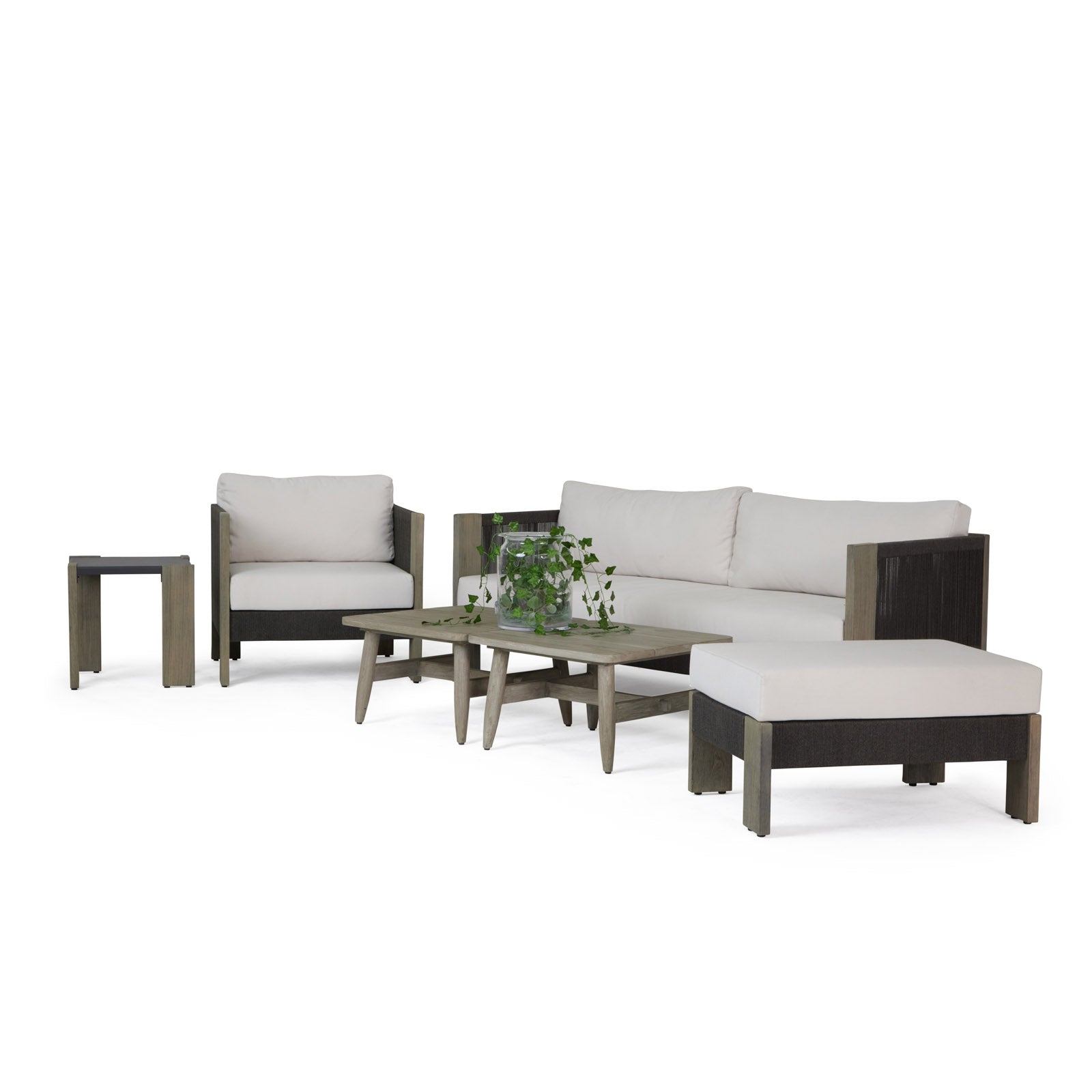 Modern patio furniture set features a cushioned sofa, armchair, and ottoman with a wooden coffee table, supporting a green potted plant, all placed on a plain white background.