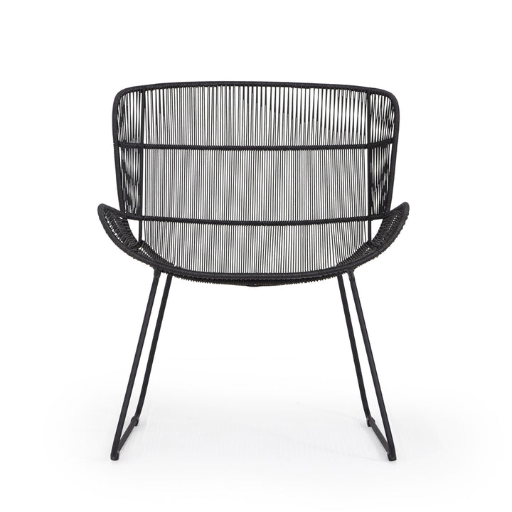 A black wire chair stands on a solid, white background. The chair features a rounded back and curved seat with slender metal legs, creating a minimalist design.