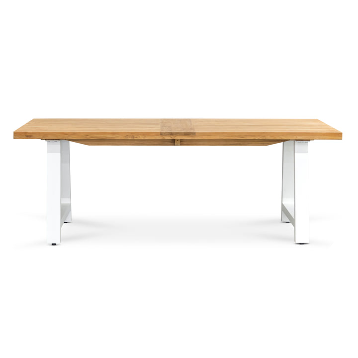 A wooden table with a rectangular top rests on white metal legs, placed against a plain white background.