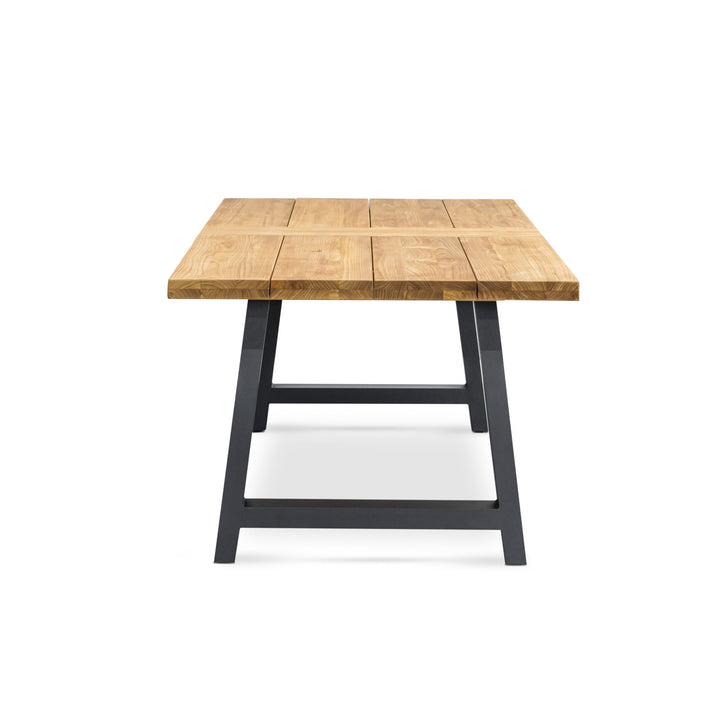 A wooden table with a plank-style top stands on black metal legs, positioned centrally against a plain white background.