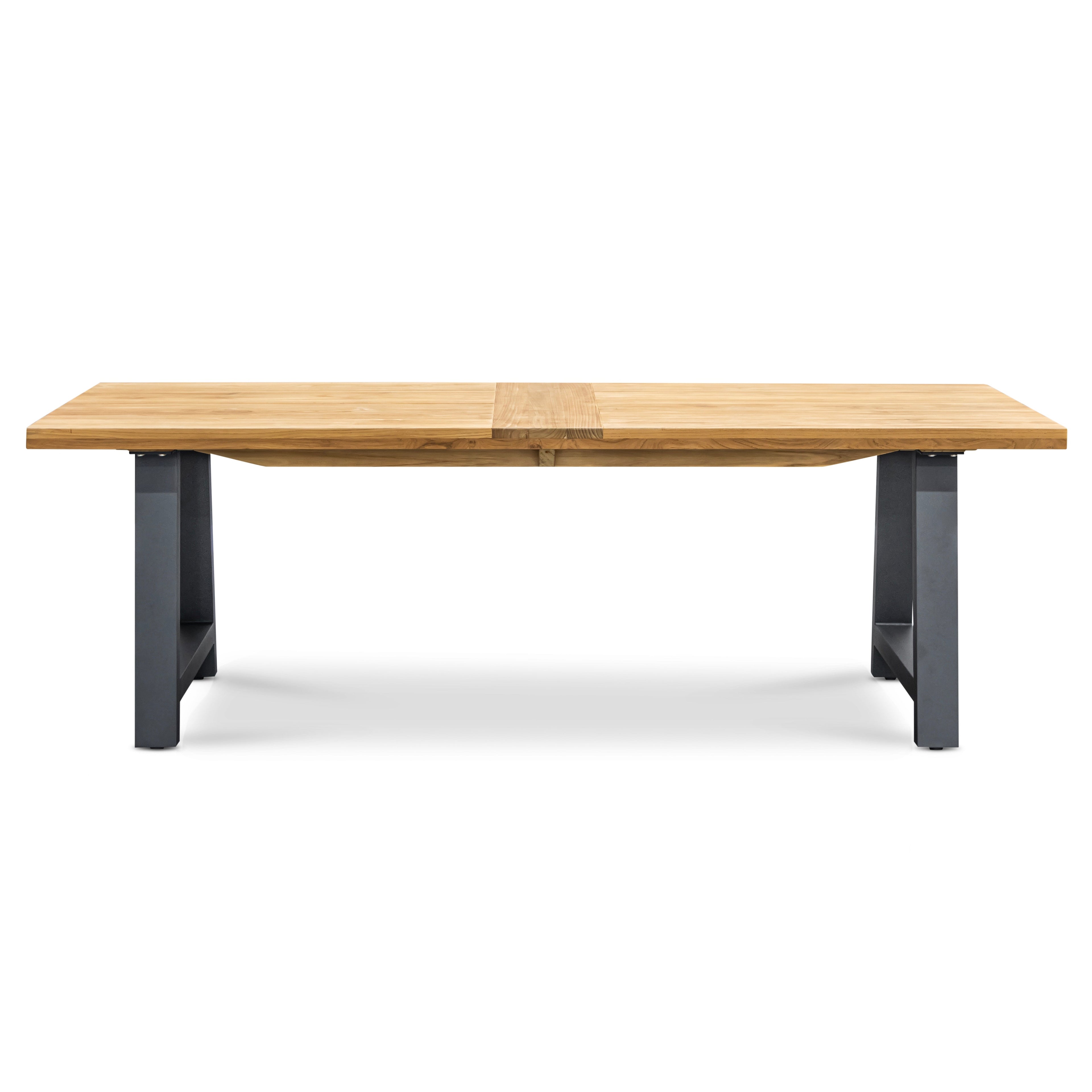 A wooden dining table with a light brown surface rests on sturdy gray metal legs, centered in a plain white background.