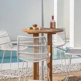 35" round teak outdoor bar table with white chairs