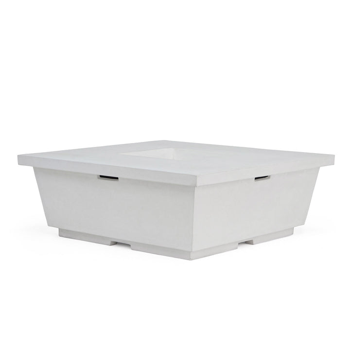 A white, square, concrete fire pit with a recessed center, sits on a flat base. It has a modern design and is placed against a plain white background.