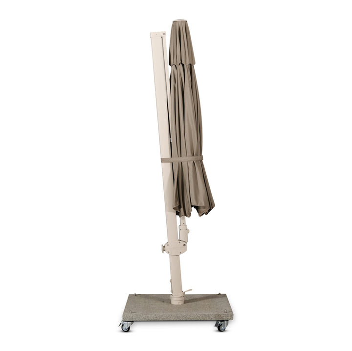 A closed beige patio umbrella stands vertically on a wheeled base, positioned against a plain white background.