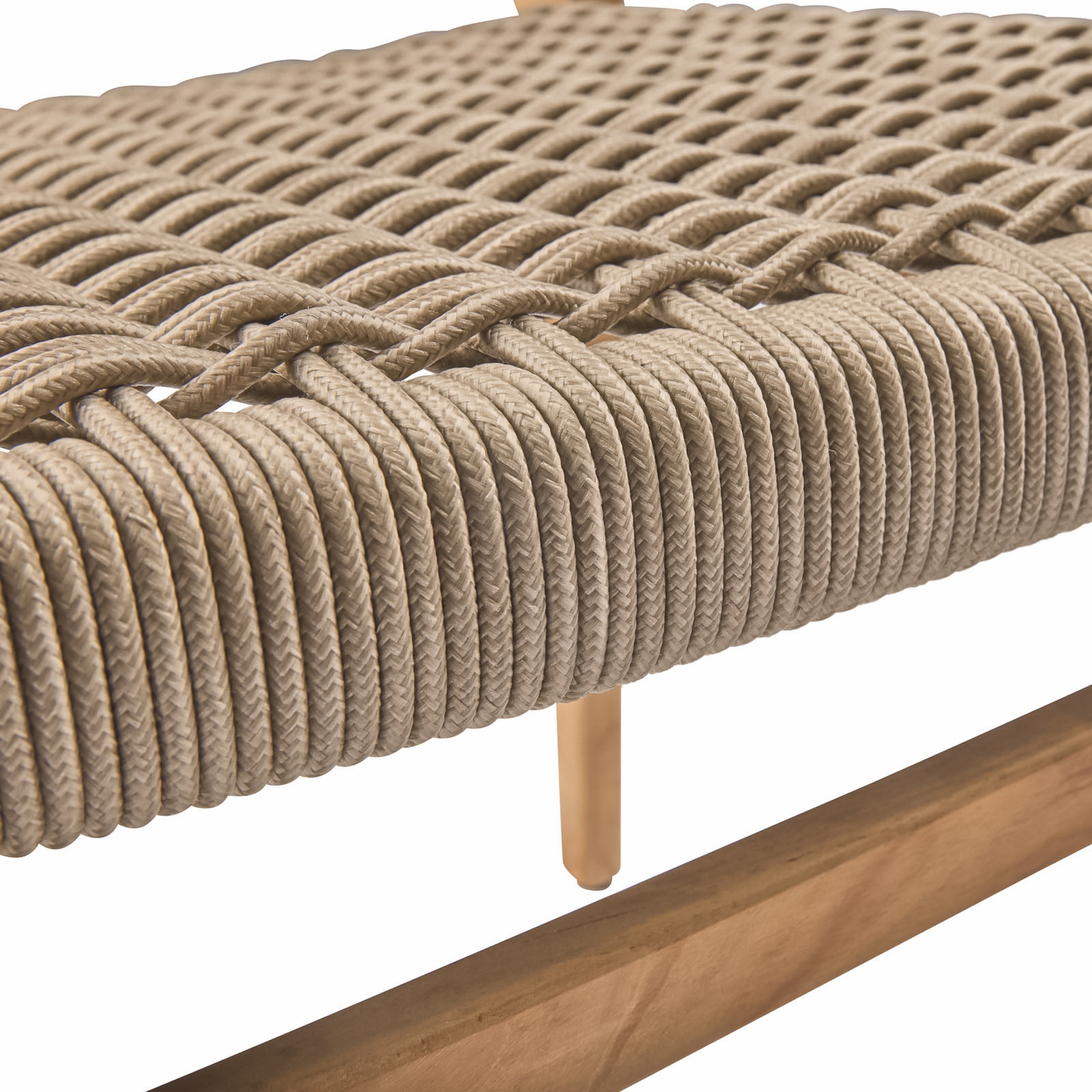 A bench features tightly wound beige rope forming a woven pattern. Wooden legs provide support, highlighting the bench's artisanal design within a minimalist indoor environment.