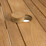 Close-up of teak wood counter height table hole plug