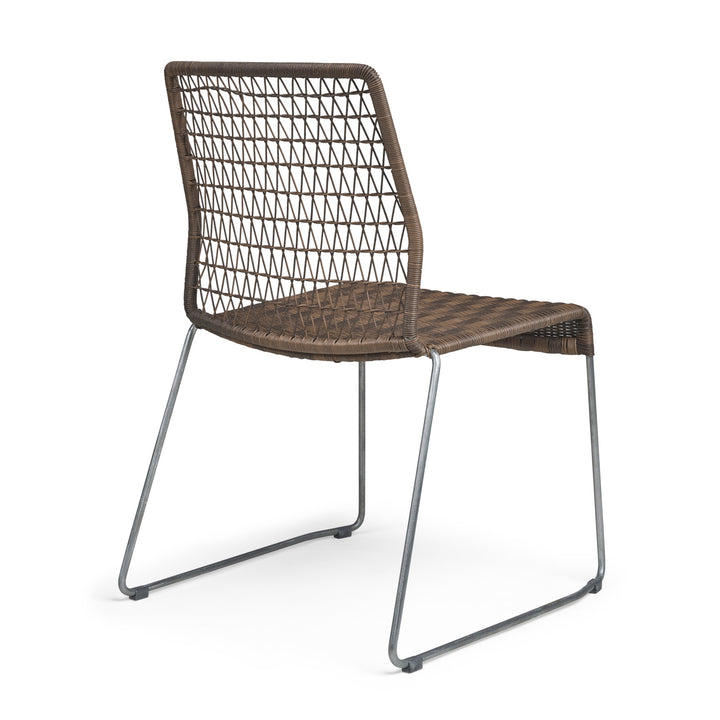 A wicker chair with a lattice back and seat, supported by thin metal legs, stands against a plain white background.