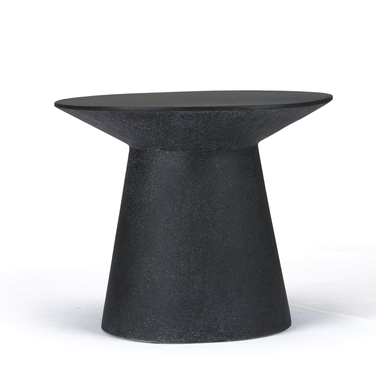 A black, stone-like, hourglass-shaped side table stands on a smooth surface, showcased against a plain white background.