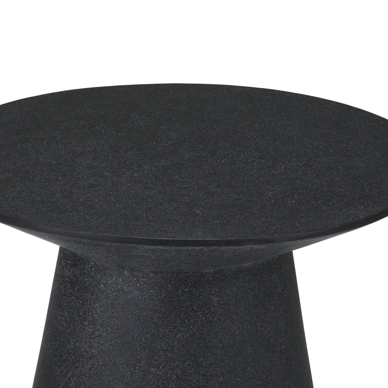 A round, dark stone table sits stationary, exhibiting a smooth, flat surface with a tapered base. The background is neutral, lacking distinct features.