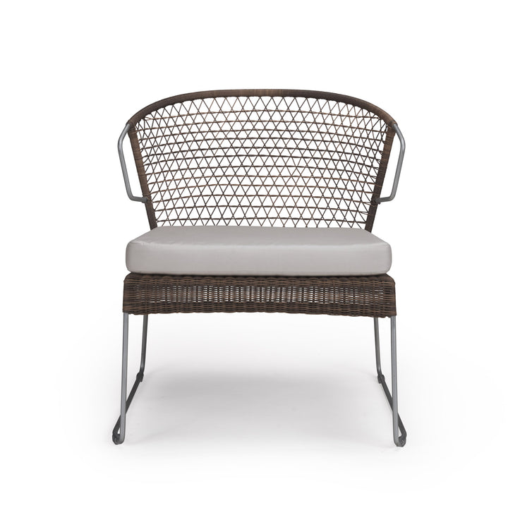 A wicker chair with a triangular pattern mesh backrest and gray cushion sits on a clean, white background. The chair features slim metal legs and armrests.