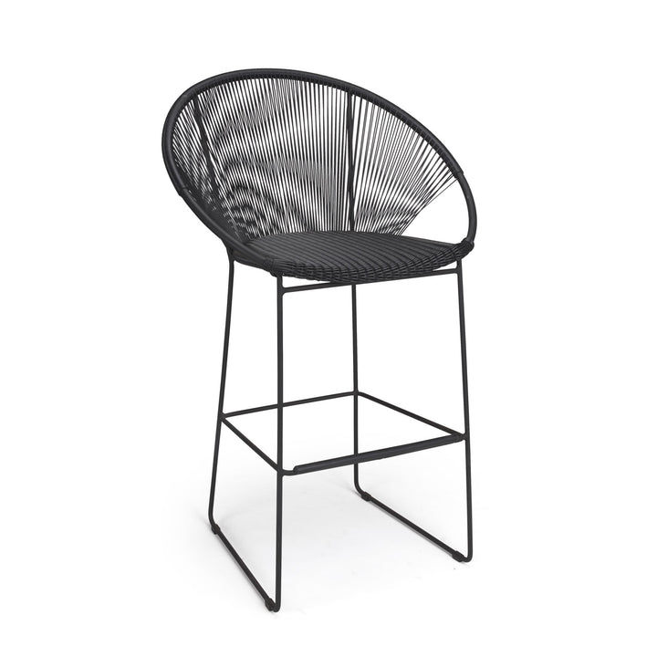 A tall, black stool with a round, woven backrest and seat stands on four slender metal legs against a plain white background.