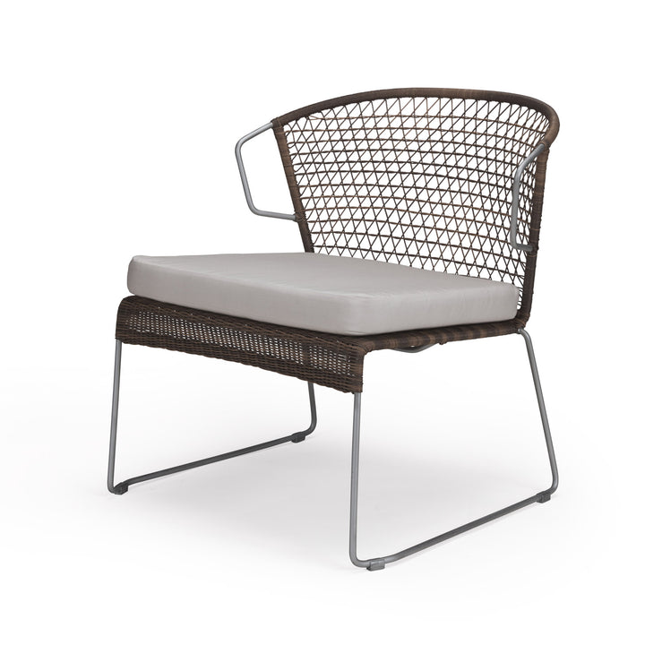 A wicker chair features a light gray cushion and wireframe support, presented against a plain white background, highlighting its modern design and open weave pattern.