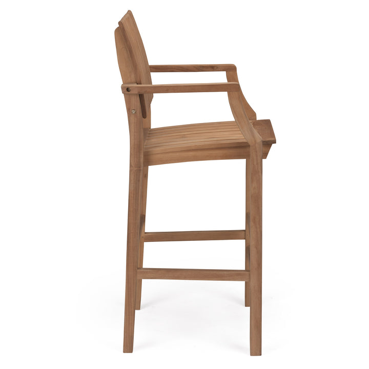 A wooden barstool is shown in profile, featuring armrests and a slatted seat, set against a plain white background.