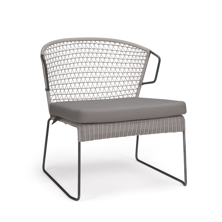 A modern chair with a light gray cushion and metal legs, featuring a woven lattice backrest, is set against a plain white background.