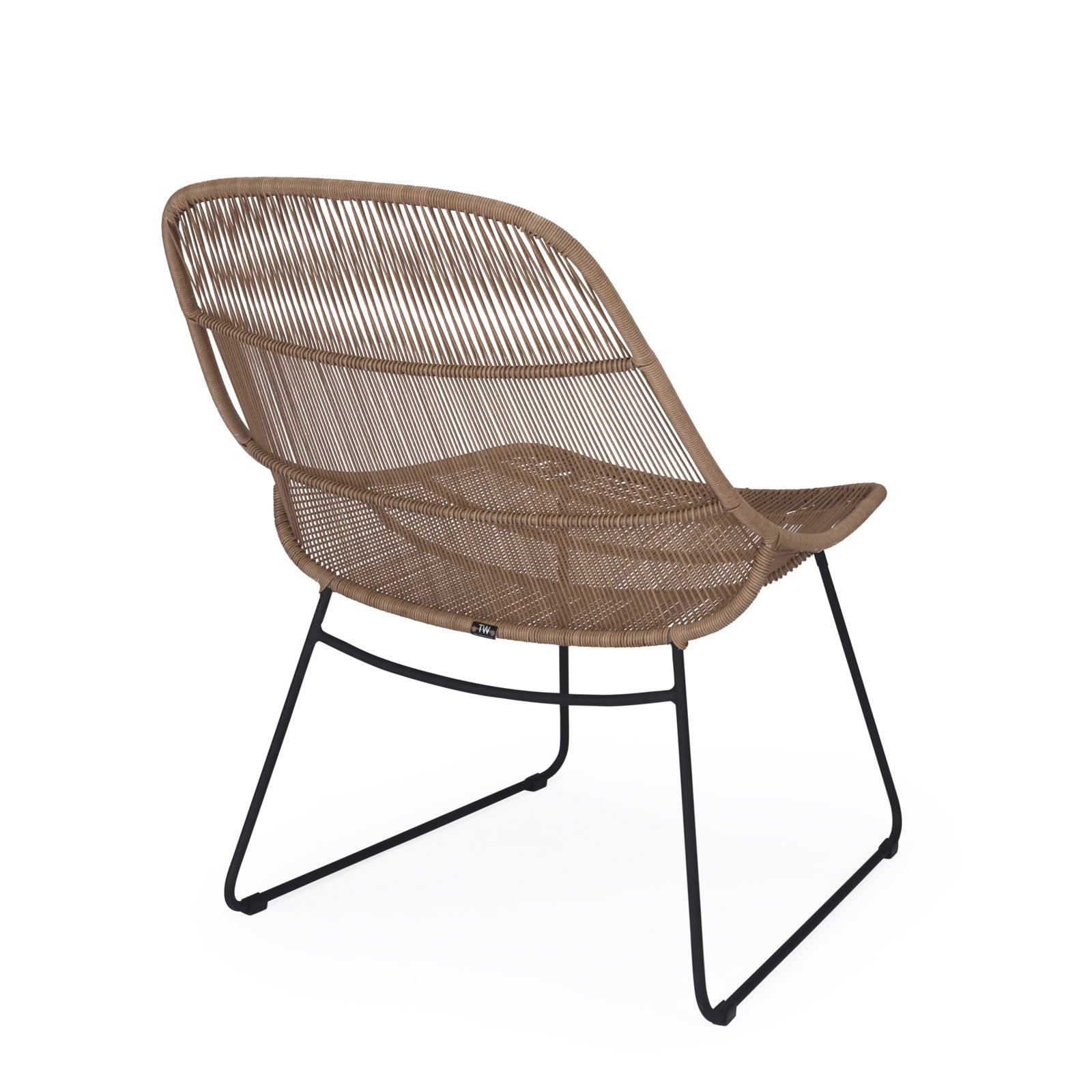 A wicker chair with a brown woven seat and backrest sits angled, supported by black metal legs, against a plain white background. A small tag reads, "Tuv."