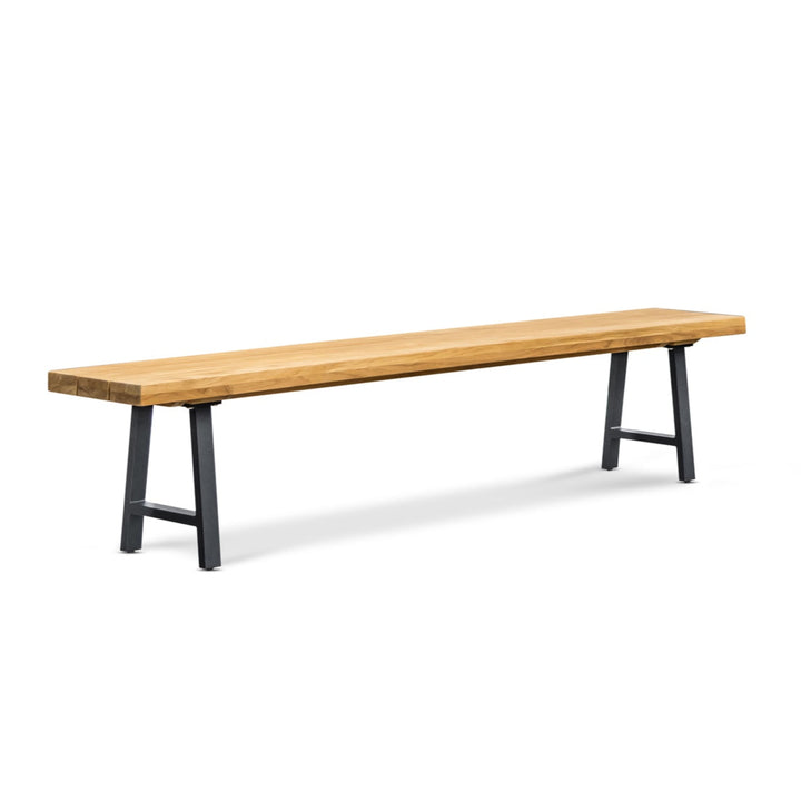 A long wooden bench is standing on black metal legs, placed against a plain white background.