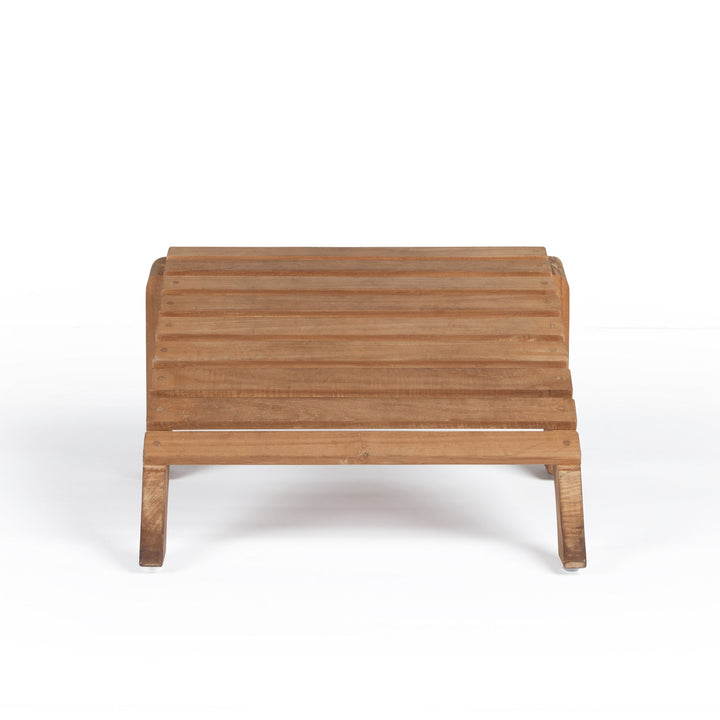 A wooden footrest with horizontal slats sits on a white background. It features simple, sturdy legs and a natural finish, designed for outdoor or patio use.