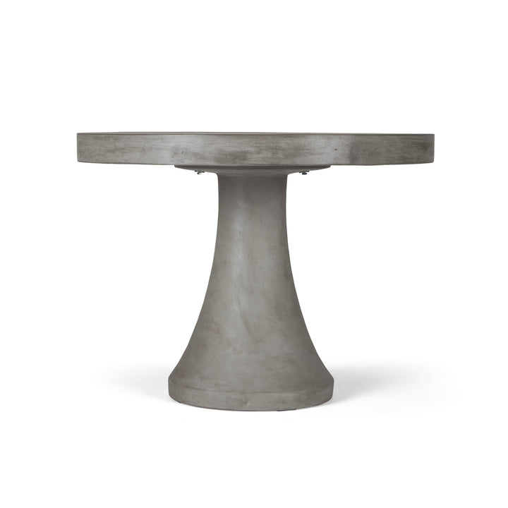 A gray concrete table with a round top rests on a smooth, tapered pedestal base, set against a plain white background.