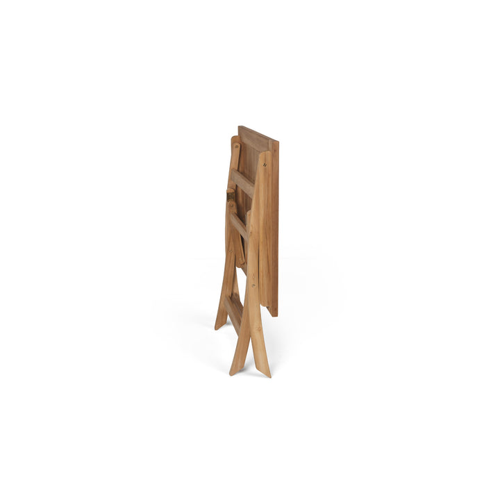 A folded wooden chair stands upright against a plain white background, showcasing its compact design and visible grain pattern.