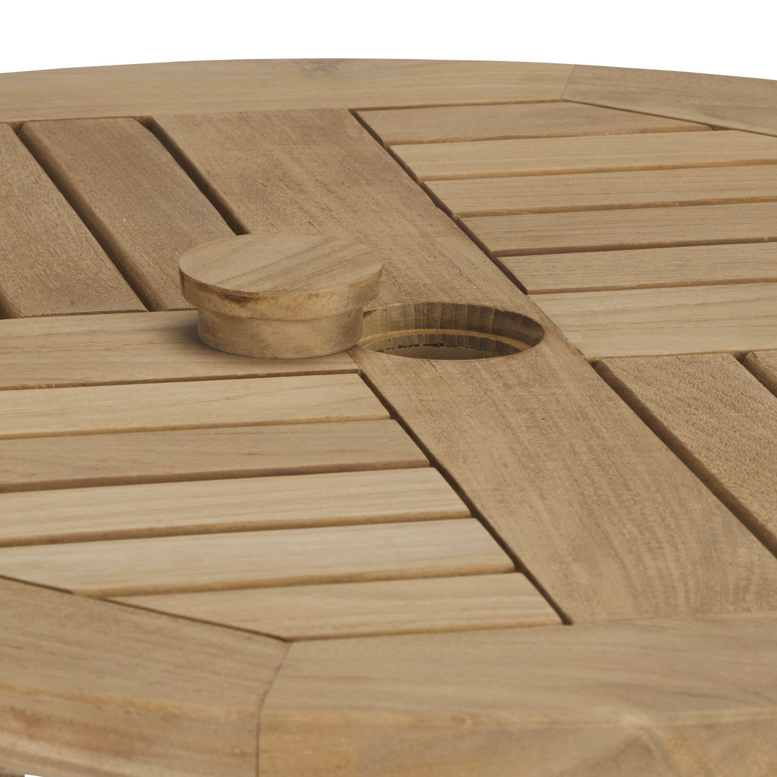 Wooden table surface featuring a central circular plug partially covering a round hole, surrounded by horizontal and vertical slats, creating a geometric pattern.