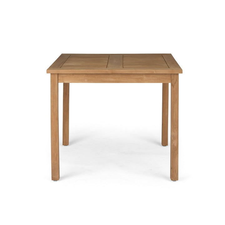 A wooden table stands with four straight legs. It is positioned in a neutral, white space, highlighting its simple, rectangular design and natural wood grain.