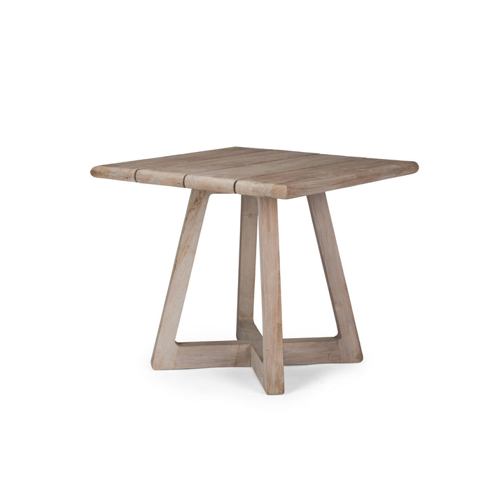 A square wooden table stands on four angled legs, forming a geometric base, positioned against a plain white background.