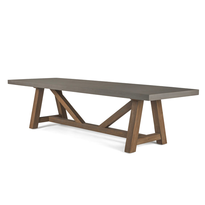 A rectangular table with a smooth gray top rests on geometric wooden legs, angled and crossed for support, against a plain white background.