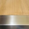 stainless steel and teak plank table closeup view