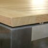 stainless and teak fixed outdoor dining table closeup view